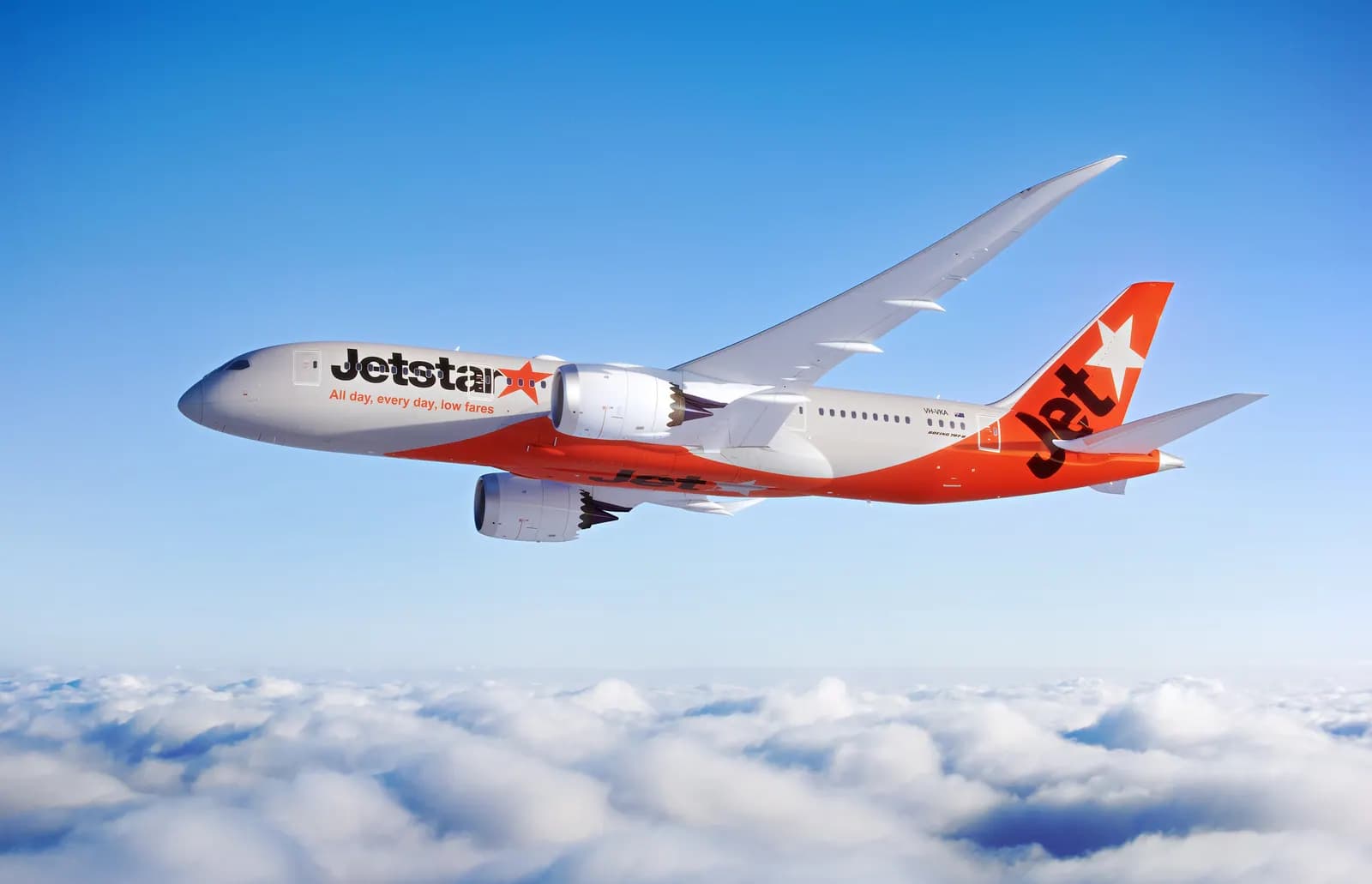 A Jetstar plane flying above the clouds